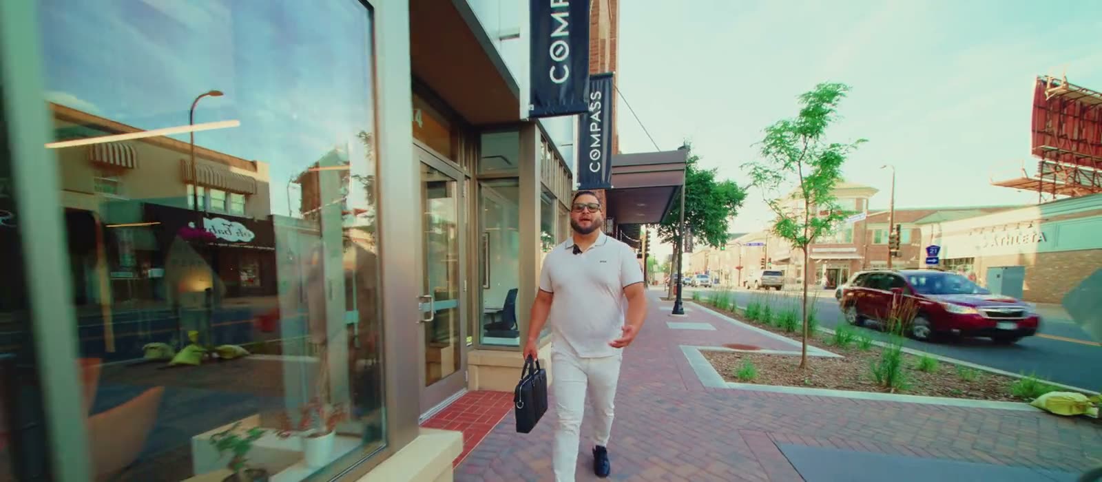 Miguel Lopez walking past the Compass office in the Twin Cities
